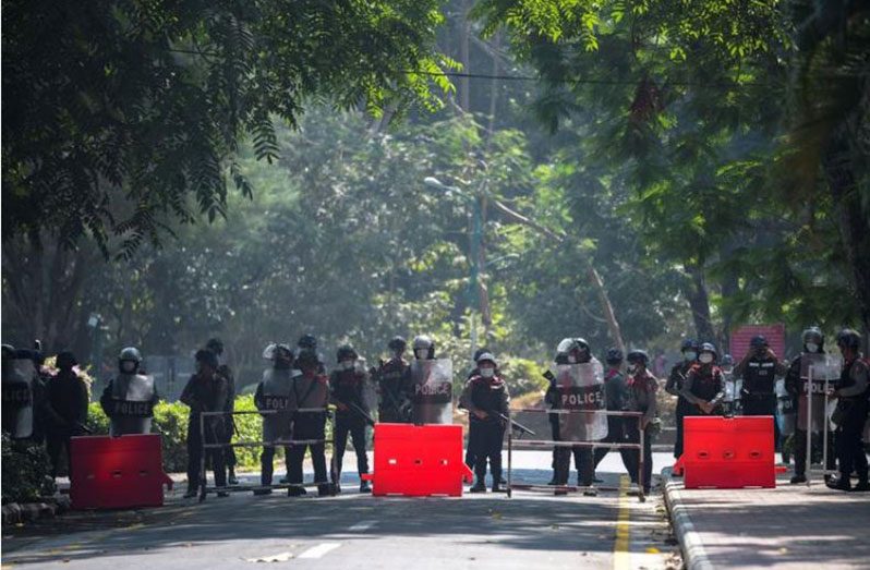 Riot police officers stand guard during a rally against the military coup at the University of Yangon, in Yangon, Myanmar, February 25, 2021 (REUTERS/Stringer photo)