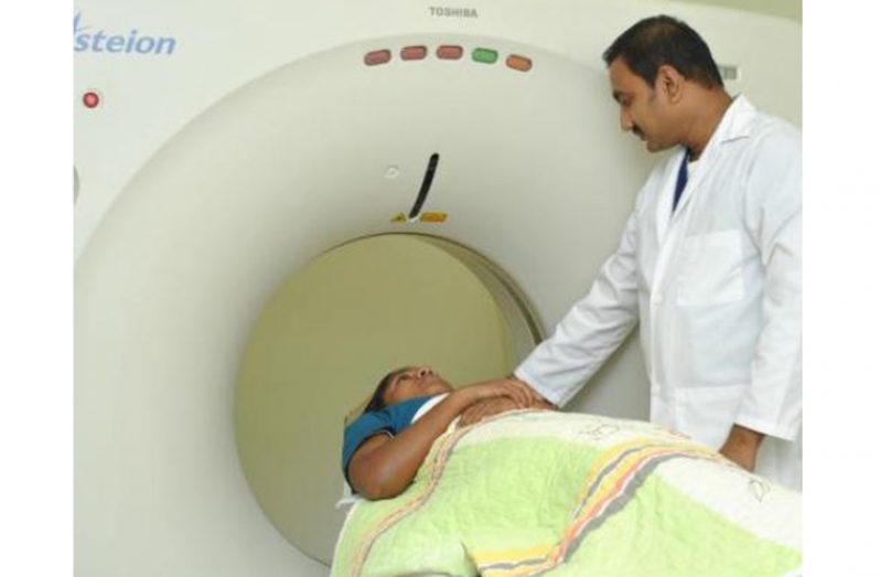 A radiographer at Dr. Balwant Singh Hospital conducting a CT scan procedure