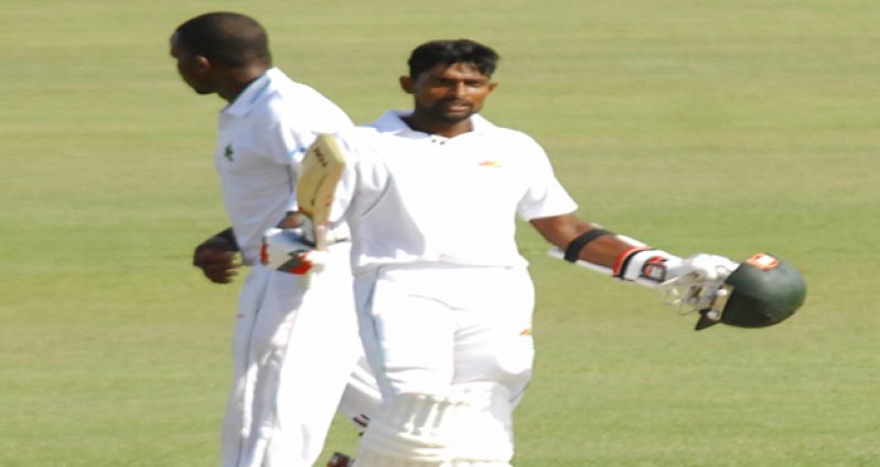 Guyana Jaguars’ Rajendra Chandrika acknowledges the spectators after reaching his centry for the first time at the First Class level.