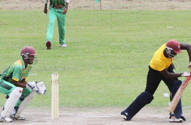 Oh my did not know he has that too! These must be the words going through the mind of wicketkeeper Kemol Savory and Shiraz Ramcharran, who look on with relief as Essequibo opener Kevon Boodie plays a rare defensive shot during his pugnacious double century yesterday. (Photo by Sonell Nelson)