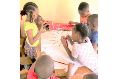Children creating a collage at the art and reading programme