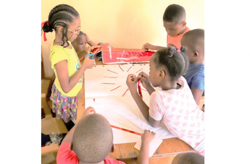 Children creating a collage at the art and reading programme