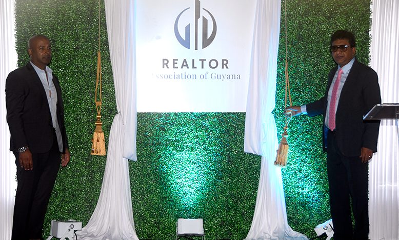 Attorney General Anil Nandlall (at right) and President of the Realtor Association of Guyana, Chief Samsair (at left) as they unveiled the logo for the newly launched association (Adrian Narine photo)