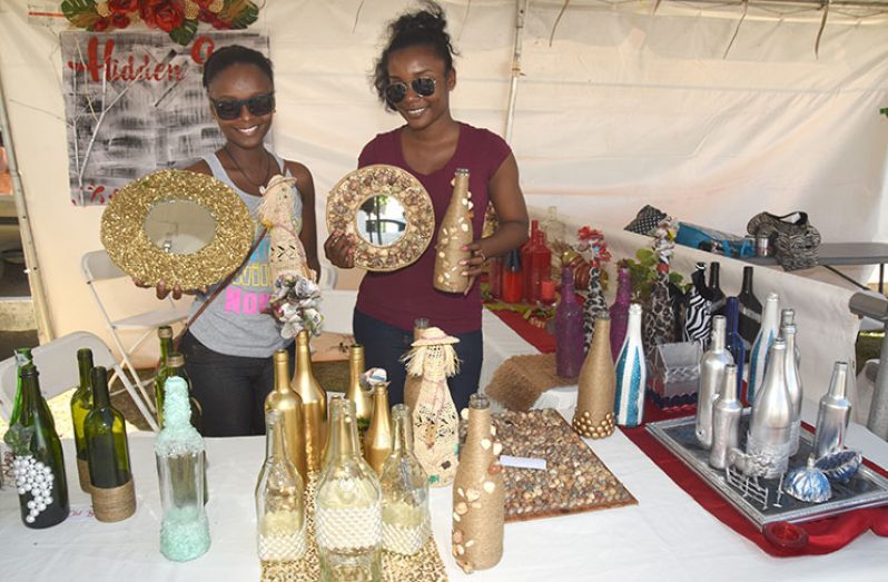 Employees of Hidden Gems showing off some of the items that were made from unwanted items. (Adrian Narine photos)