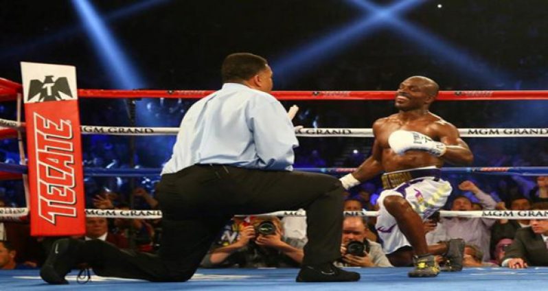 Referee Tony Weeks counts as Timothy Bradley gets up after being brought down by Manny Pacquiao at MGM Grand Garden Arena. Mandatory Credit: Mark J. Rebilas-USA TODAY Sports