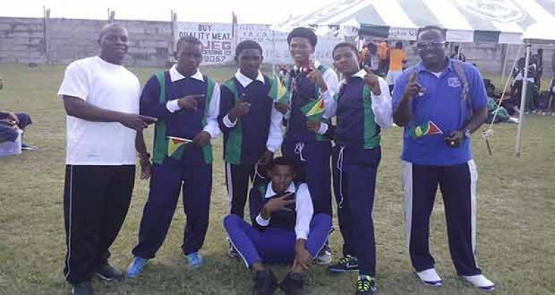 Some of the members of the Tutorial High Boys Under-15 with team manager, Kirk Moses (right).