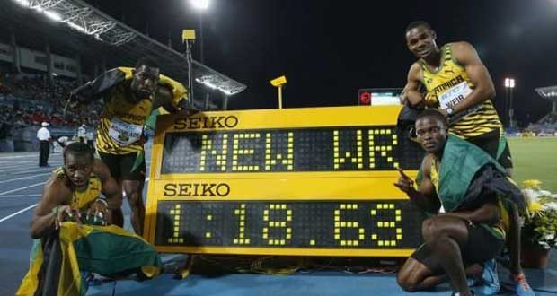 Jamaica's 4x200 relay team pose next to the clock after they set a new world record while winning the 4x200 metres relay at the IAAF World Relays Championships in Nassau, Bahamas on Saturday. At left is Nickel Ashmeade (top), Yohan Blake (bottom) and at right is Warren Weir (top) and Jermaine Brown (bottom). (Credit: Reuters/Mike Segar)