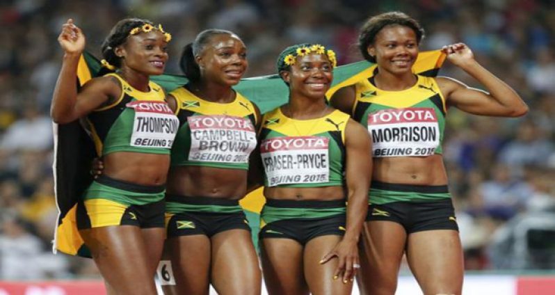 Elaine Thompson, Veronica Campbell-Brown, Shelly-Ann Fraser Pryce and Natasha Morrison of Jamaica react after winning the women's 4x100m relay during the 15th IAAF World Championships at the National Stadium in Beijing, China, yesterday. (Reuters/Lucy Nicholson)