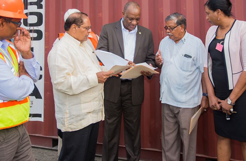 Prime Minister Moses Nagamootoo and Minister of State Joseph Harmon at the Laparkan Wharf moments before the vessel taking the containers set sail (Photo by Samuel Maughn)