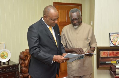 Francis Carryl, who was tasked with conducting the Board of Inquiry, explains a part of the Report to Minister of State, Mr. Joseph Harmon