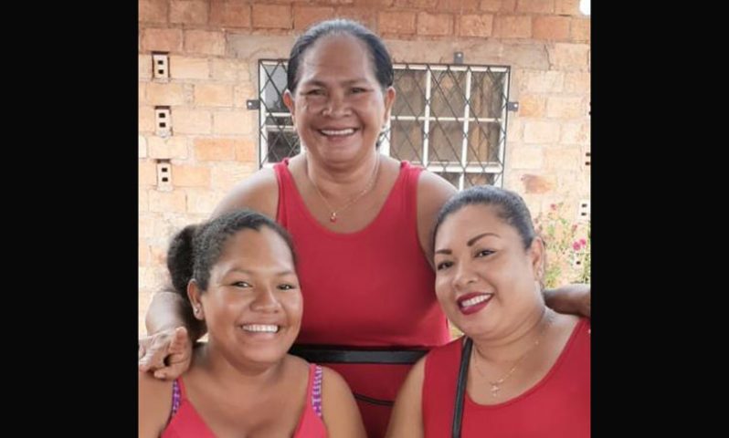 Beverly Rodrigues, 58, (centre) with her daughters, is looking forward to owning her home