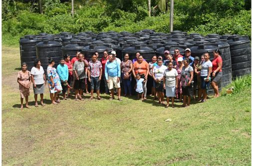 Minister of Housing and Water, Collin Croal and residents of Region One during the distribution of water tanks