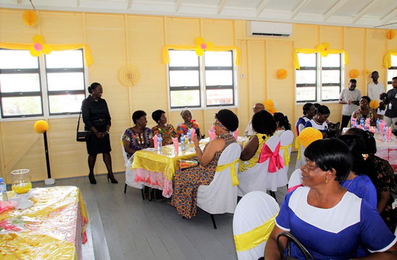 Minister Henry greeting the retired headteachers
