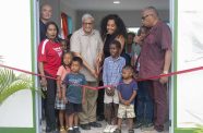 DDL Chairman/CEO, Komal Samaroo flanked by invitees and locals in the ribbon-cutting exercise, signalling the opening of the Moblissa Community Centre (Japheth Savory photo)