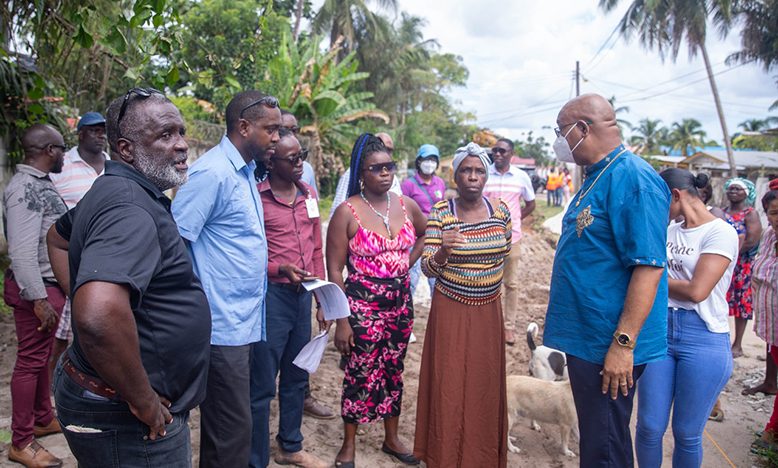 Public Works Minister, Juan Edghill interacting with residents during the site visits