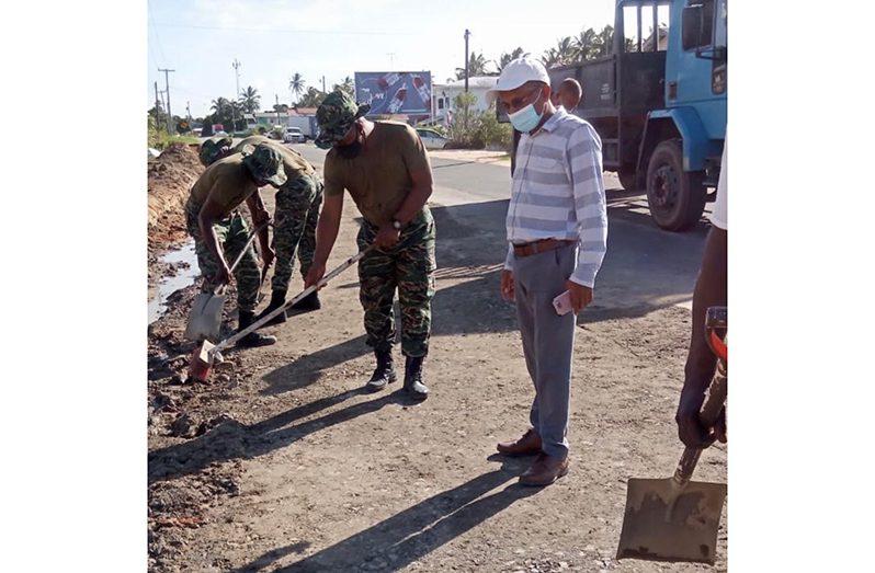 Regional Vice-Chairman Humace Odit (right) inspecting the work being done by GDF ranks on the Adventure Road