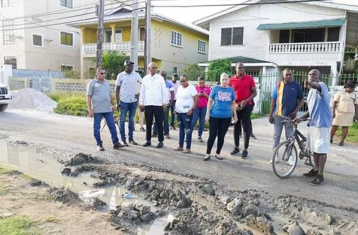 Minister of Public Works, Bishop Juan Edghill, the Minister of Housing and Water, Collin Croal and other officials inspect the section of Rosa Drive that is in a bad state