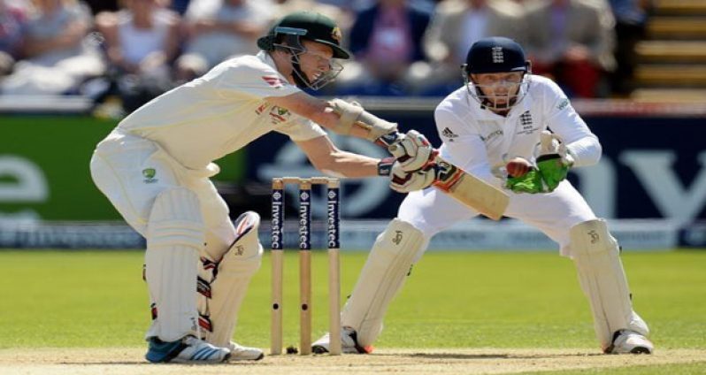 Chris Rogers goes on the attack while wicketkeeper Jos Buttler looks on.