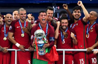 Cristiano Ronaldo (C) of Portugal of lifts the Henri Delaunay trophy at the end of their UEFA EURO 2016 final match against France