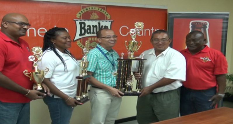 Banks Beer Brand manager Brian Choo Hen (centre) hands over the Championship Trophy to GRFU president Peter Green following the tournament launch.
