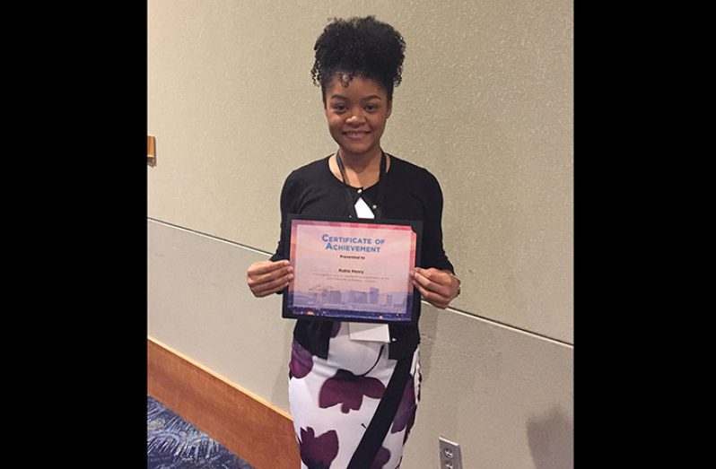 Rukia Henry with her Achievement Award in the Neuroscience Category from ABRCMS