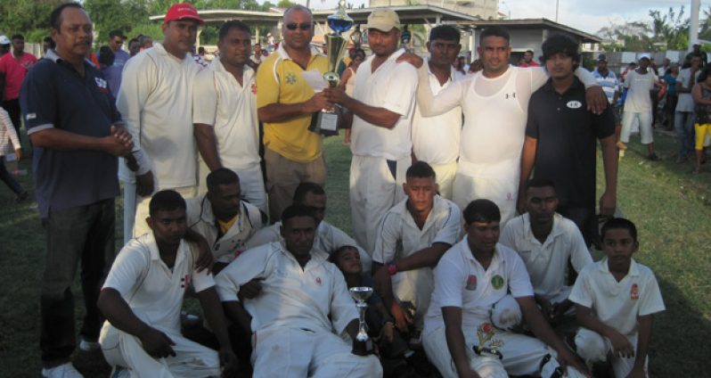 Sachin Ramrattan captain of No. 69 Vikings together with teammates receives the winning 4R T20 trophy from sponsor Mr. Ricky Deonarain.