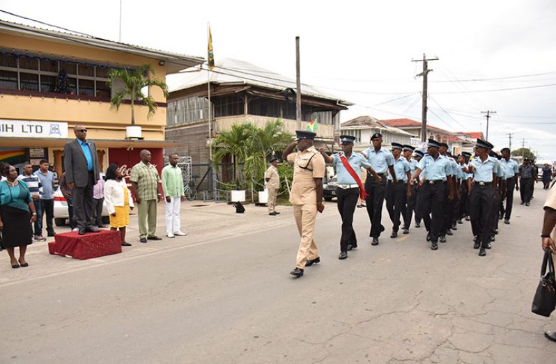 Minister of State, Mr. Joseph Harmon taking the salute from members of the Guyana Police Force during the march past