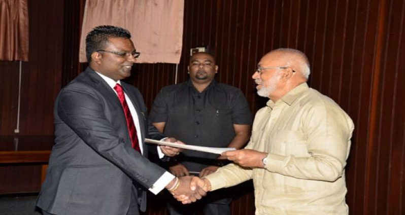 President Donald Ramotar swearing in the newly appointed PPP GECOM Commissioner, Attorney-at-Law, Sase Gunraj