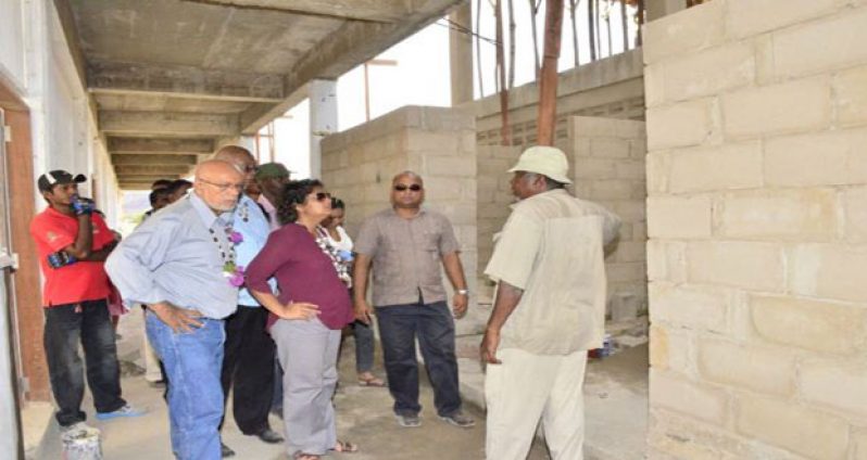 President Donald Ramotar, Education Minister, Priya Manickchand, Minister in the Ministry of Finance, Juan Edghill, and Regional Executive Officer, Region Eight, Ronald Harsawack checking out an area of the school under construction