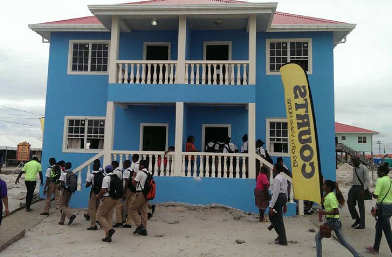 Students being given a tour of the various models of houses on display at the Perseverance Housing Scheme