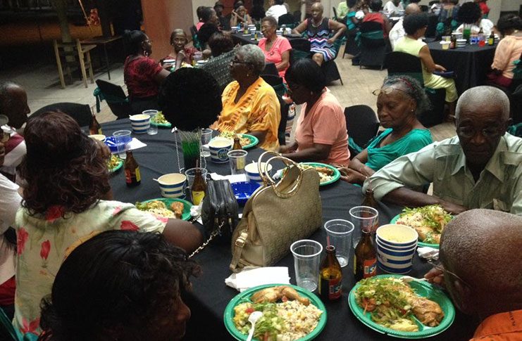 Wisroc seniors who are now members of the Green Jaguars Senior Citizens Group enjoying the sumptuous meal prepared for them at the Christmas party