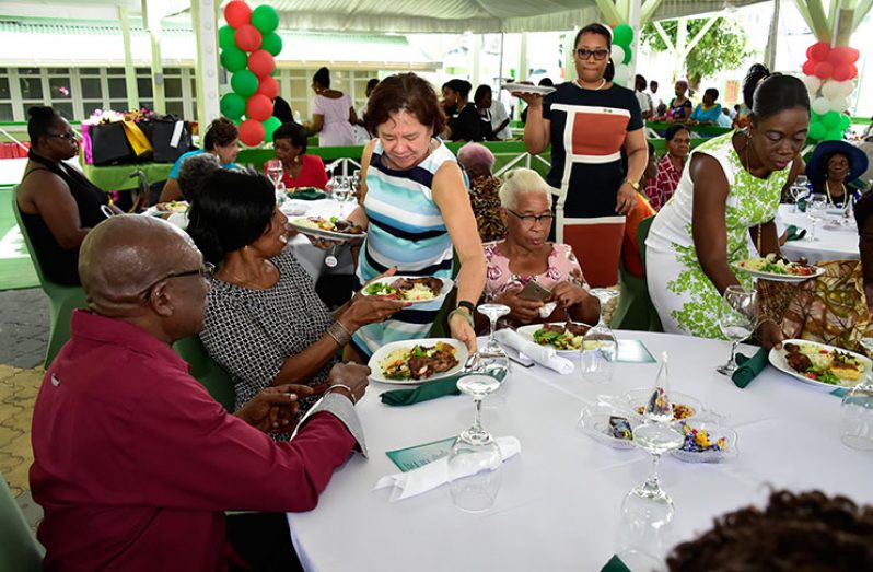 First Lady Mrs. Sandra Granger serving lunch to senior citizens at the Baridi Benab at State House