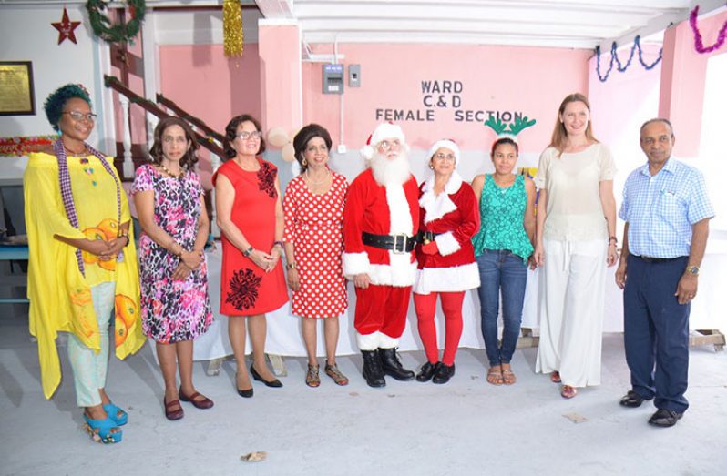 First Lady, Mrs. Sandra Granger (third from left) is flanked by Pamela and Kella Ramsaroop at the Dharm Shala’s Christmas party for children. Executive Member of the Board of the Dharm Shala, Mr. Edward Boyer and Mrs. Ruta Drizyte-Videtic, the wife of the European Union Ambassador to Guyana, are pictured first and second from right.