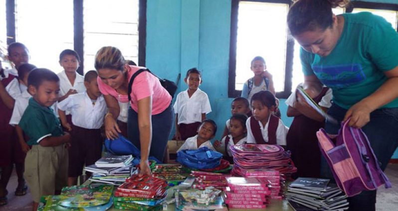 Global Shapers members preparing school packages for children