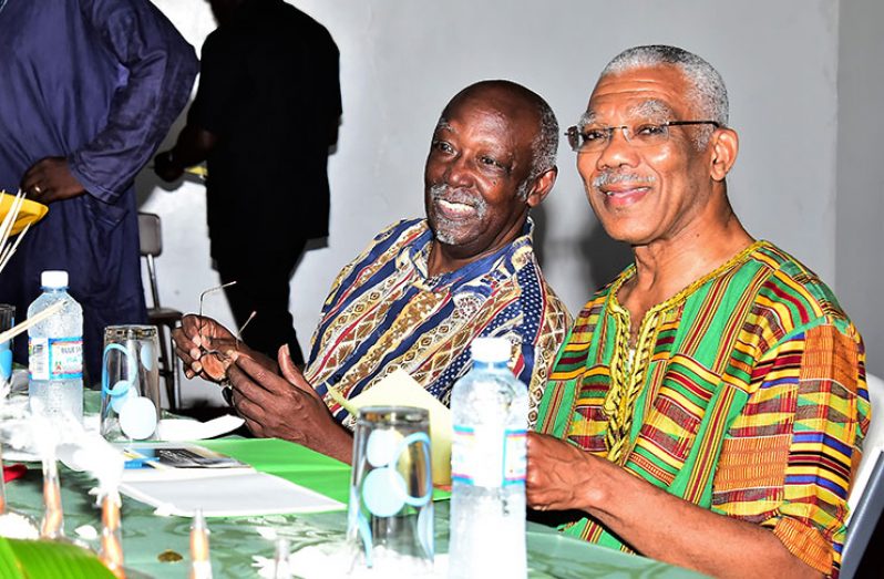 President David Granger shares a light moment with President of the Pan-African Movement Guyana Branch, Clement Duncan at the opening ceremony of the 29th Anniversary Conference
