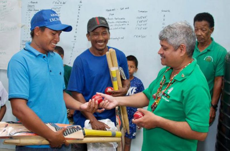 Minister Sharma present cricket gear to members of the Potarinau club