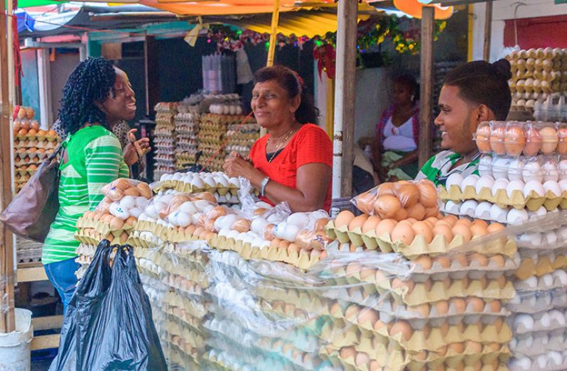 A shopper enquires about the price for a tray of eggs in the Bourda Market