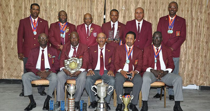WIFBSC Short Range champs 2016, Guyana, display trophies and medals after winning the WIFB Short Range and Wadadli Cups as well as other Individual trophies and medals. Seated from right are Paul Slowe, Dylan Fields, Mahendra Persaud, Lennox Braithwaite and Ransford Goodluck. Standing from left are Peter Persaud, John Fraser, Terrance Stuart, Sherwin Felicien, Leo Romalho and Ryan Sampson.