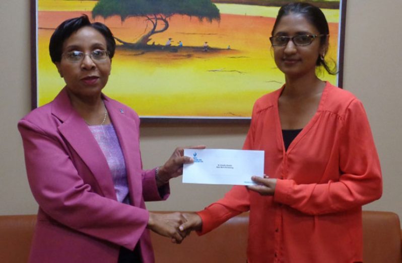 GBTI’s Head of Banking Operations, Mrs Collette Lyken-Ramdial hands over the donation to Dr Bibi Alladin-Karan of the New-Born Screening project .