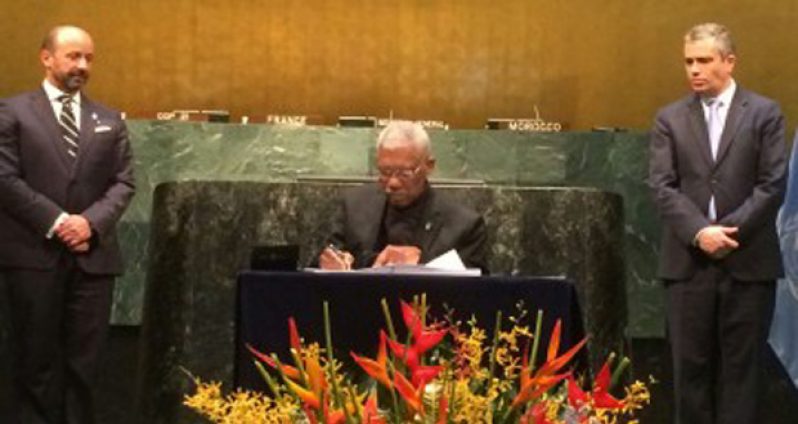 President David Granger signs the ambitious Paris Agreement at the UN, New York, on Friday (Ministry of the Presidency photo)