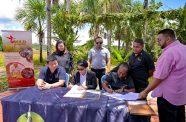 Stephen Su, President of the Chinese Association of Guyana; Minister of Tourism, Industry and Commerce, Hon. Susan Rodrigues and Shabana Daniels of Wild Adventures signing the Memorandum of Understanding (MoU) to develop and promote Hope Town, as a tourism product (Ministry of Tourism, Industry and Commerce photos)
