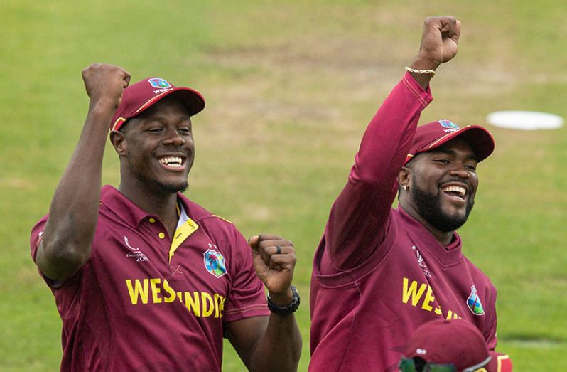 Carlos Brathwaite and Ashley Nurse sing with the crowd during a rain break © Getty Images