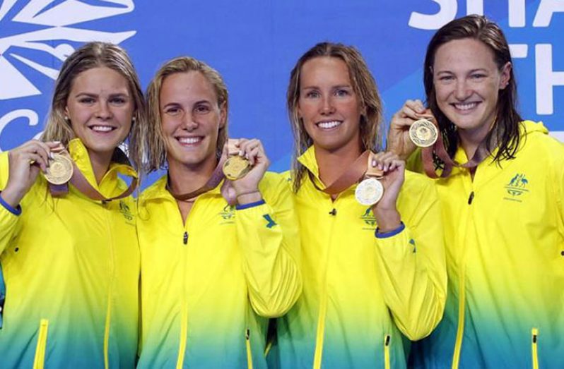 Gold medallists Shayna Jack, Bronte Campbell, Emma McKeon and Cate Campbell of Australia celebrate on the podium. (REUTERS/David Gray)