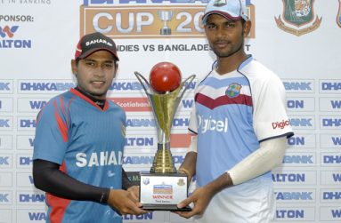 Captains Mushfiqur Rahim (left) and Denesh Ramdin pose with the series trophy, yesterday
