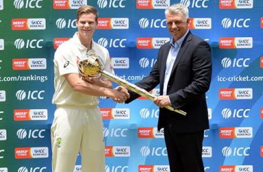 Aussie skipper Steve Smith receives the ICC Test championship mace from Chief Executive David Richardson.