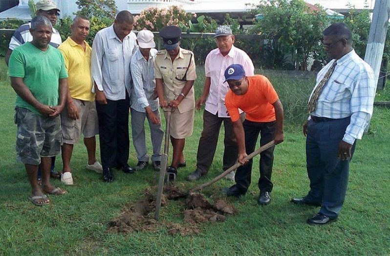 Members of the Guyana Police Force, donors and residents join in the turning of the sod ceremony.