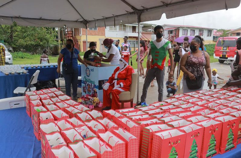 Santa Claus and his helpers prepare to distribute the toys
