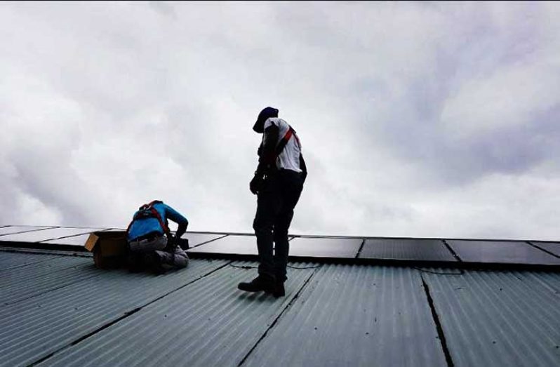 Technicians Installing PV Panels at Diamond Secondary Seconadary, East Bank Demerara