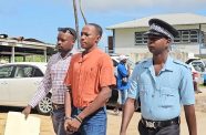 Edwards being escorted to the Blairmont Magistrate’s Court on Tuesday where he faced an attempted murder charge