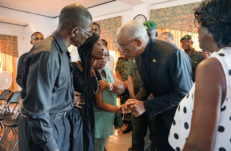 President David Granger comforts Mrs. Tamica Rose, the wife of the late Guyana Defence Force (GDF) Corporal, 21331 Seon Rose